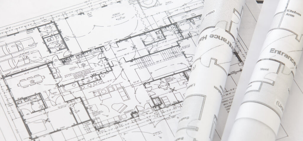 building a barndominium in texas floor plan laid out on architect's drafting board