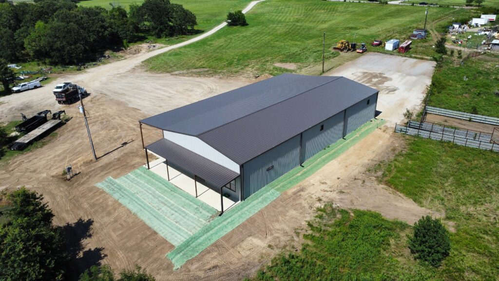Steel building prices include grading, seeding, and soil erosion measures at Trinity Metalworks, like this metal building. You can see from the aerial view.